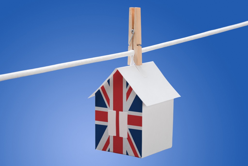 Housing-policy-house-with-British-flag-hanging-on-a-line-1024x685.jpg