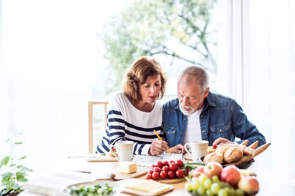 midde-aged-equity-release-couple-older-55-mortgage-sums-calculate-budget.webp