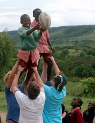 Oundle pupils and Kenyan children playing rugby during the School's visit to Kenya's Rift Valley